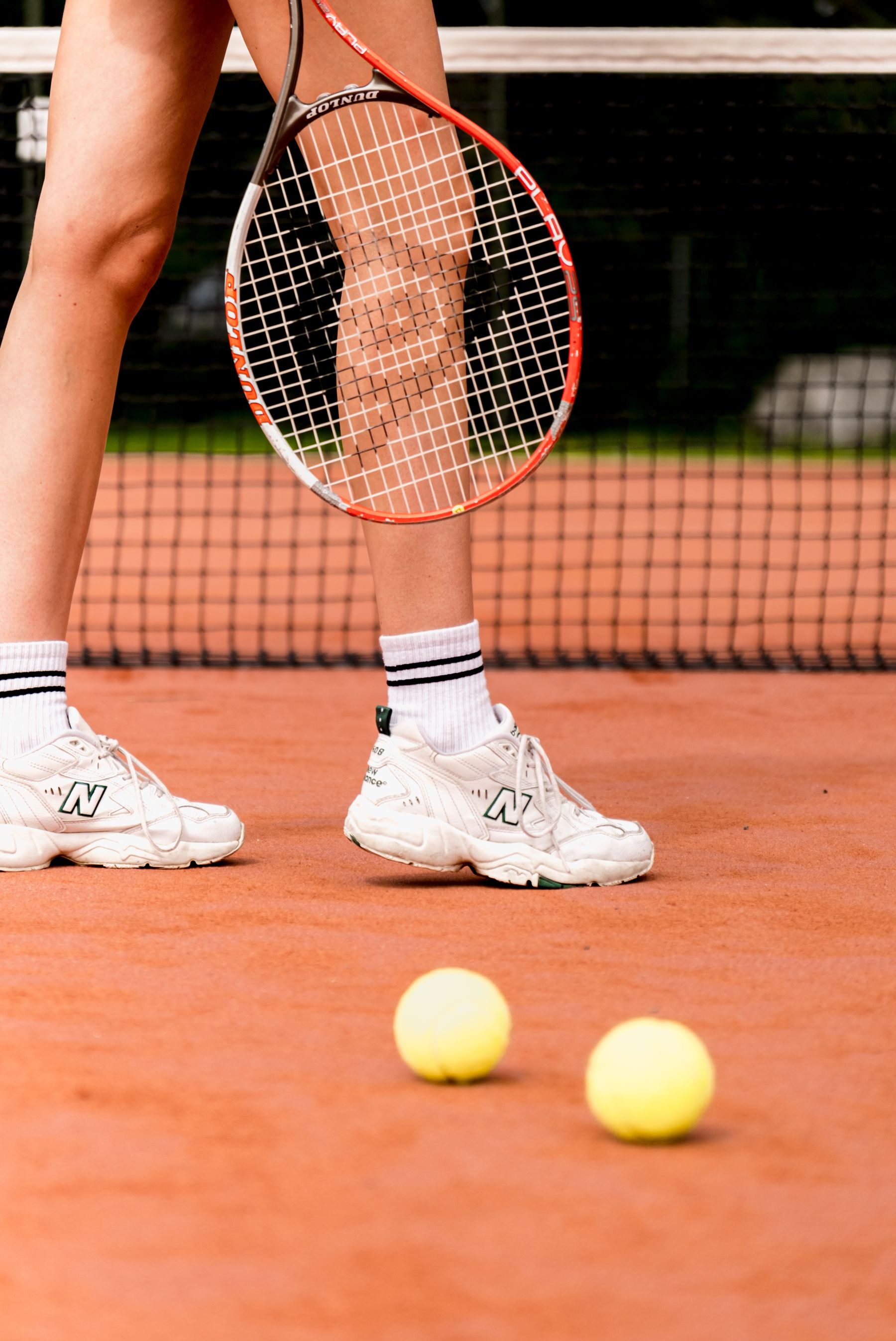Practice balls laid out on court for a beginner footwork drill
